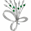 A large 14 carat white gold brooch in a floral design set with diamonds and emeralds